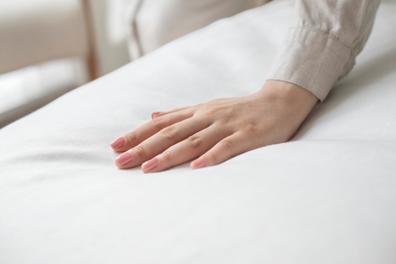 woman checkinf mattress firmness